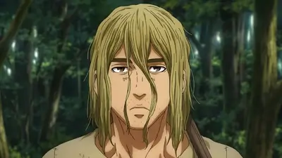A blonde-haired man stares with solemn expression amidst a blurry forest background