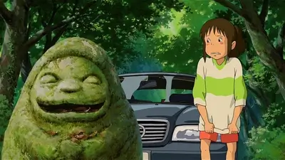A girl stands before a moss-covered stone figure