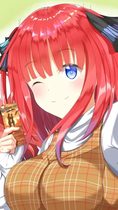 A girl with red hair winks, holding a booklet