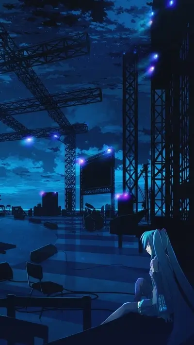 A lonely figure sits in a dark, empty space