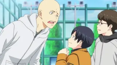 Bald teenager talking to his friends at an ice rink
