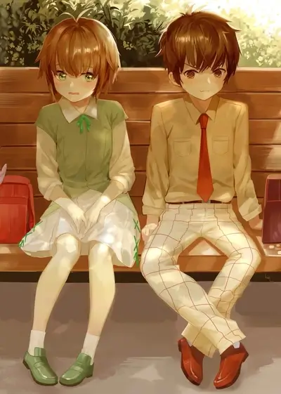 Boy and girl sitting on a park bench