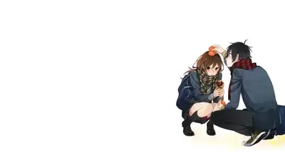 Boy placing a mandarin orange on a girl's head