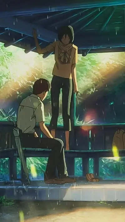 Boy sitting next to standing woman under gazebo during rain