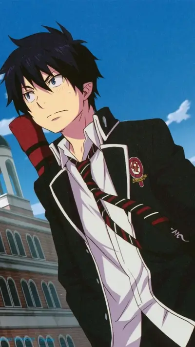 Boy with black hair in school uniform stands outside a building