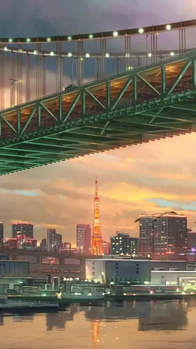 Bridge over water with city skyline and Tokyo Tower in the background