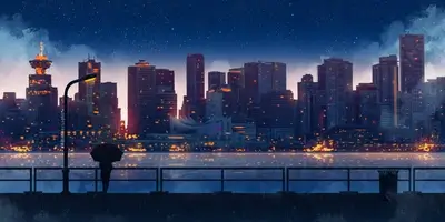 City lights reflect on water at night, silhouetted person stands under umbrella.