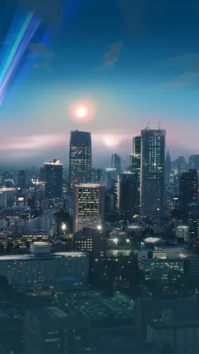 City skyline at dusk with rainbow and colorful sky.