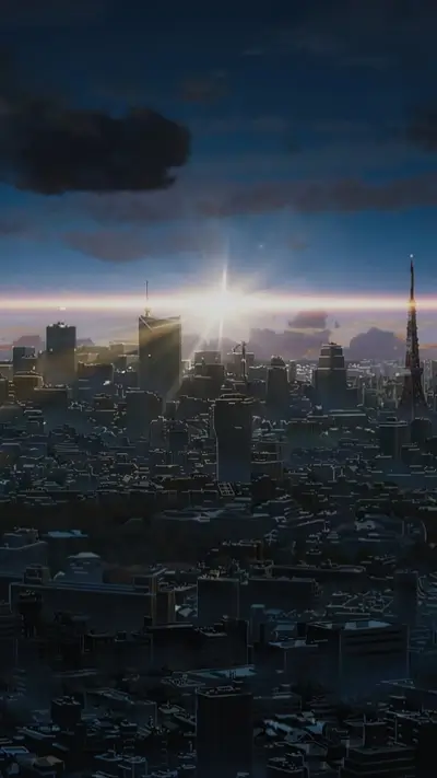 Cityscape with tall buildings beneath a bright sky, tower in distance