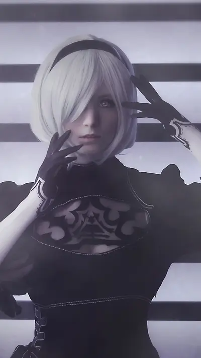 Cosplayer dressed as 2B from NieR:Automata, striking elegant pose