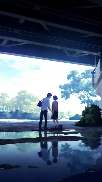 Couple holding hands under a bridge