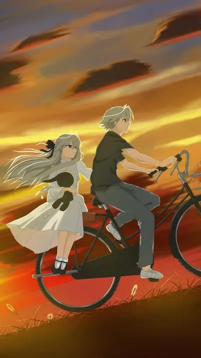 Couple riding a bicycle at sunset