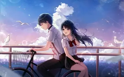 Couple riding a bicycle by the sea