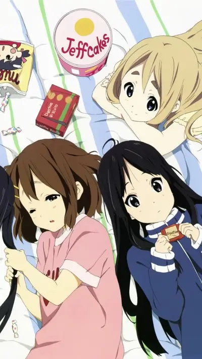 Cute girls relaxing, enjoying sweets on a striped sheet