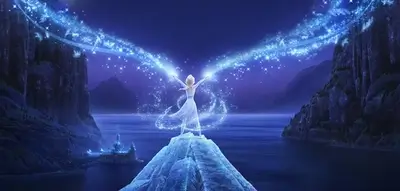 Elsa standing on a mountaintop, magical energy emanating