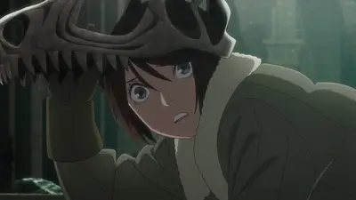 Girl holding dinosaur skull with wide surprised expression