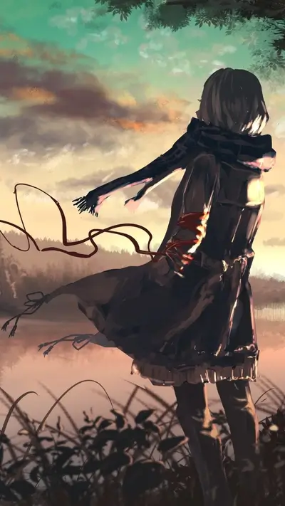 Girl in coat standing by lake at sunset