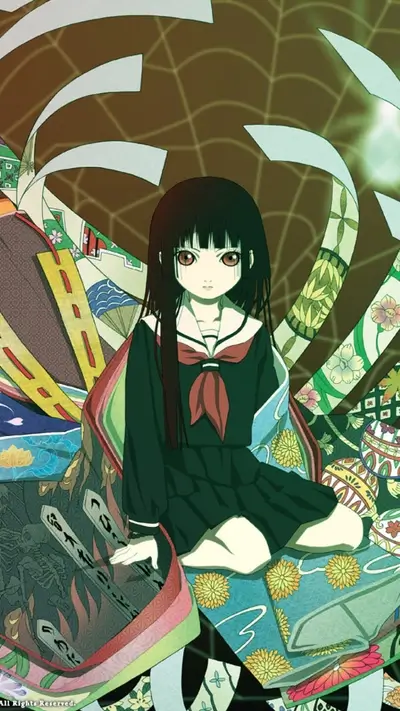 Girl in dark clothing sitting amidst colorful fabrics