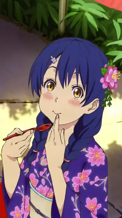 Girl in yukata eating with a spoon