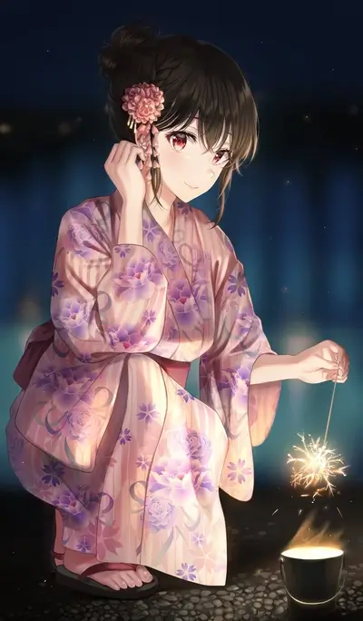 Girl in yukata holding a sparkler at night