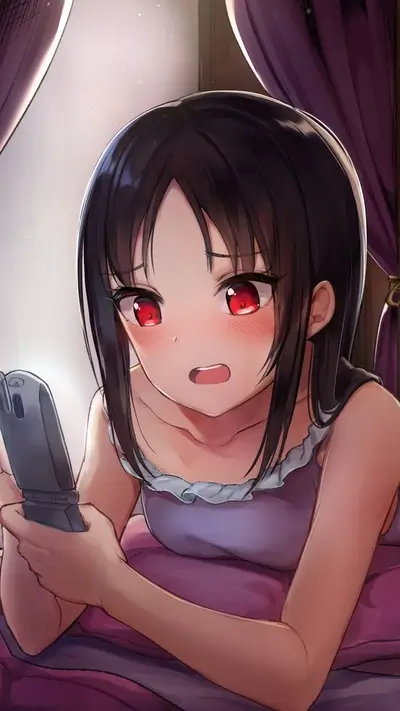 Girl looking at phone in bed