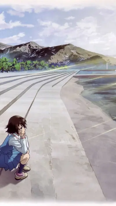 Girl sits by the sea, mountains in the background