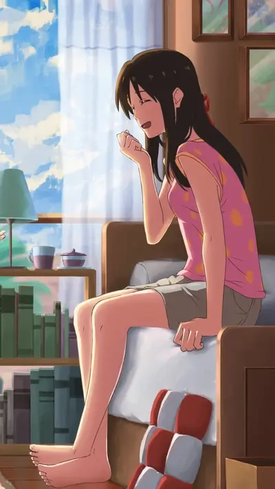 Girl sitting on a bed near a window