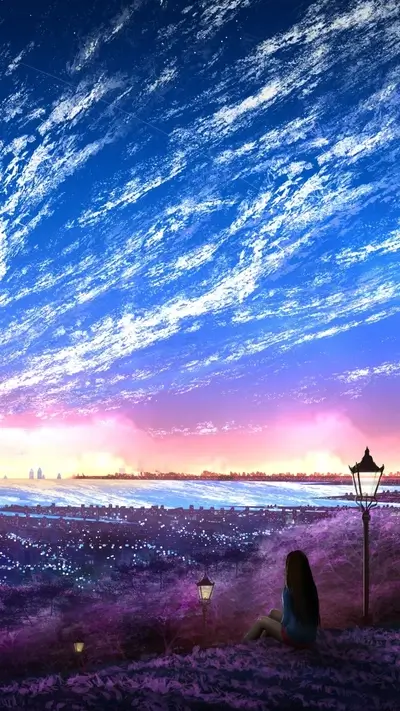 Girl sitting on a hill overlooking a cityscape, sunset sky with wispy clouds