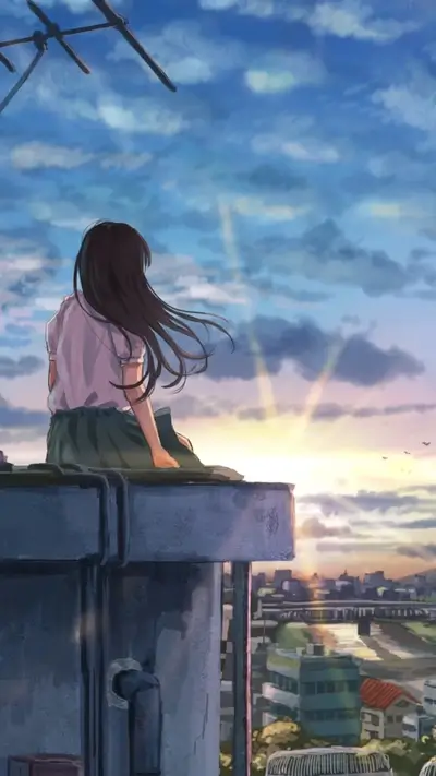 Girl sitting on a rooftop at sunset