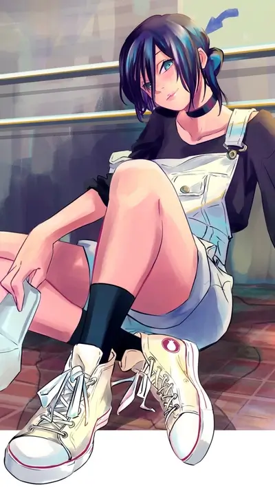 Girl sitting on the floor wearing overalls and sneakers