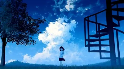 Girl standing in a field under a blue sky