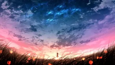 Girl standing in a field under a vibrant sky