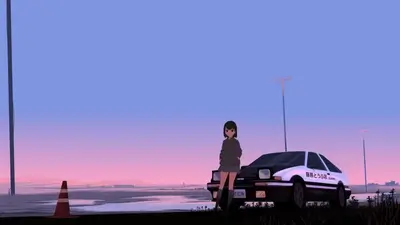 Girl standing next to a car at sunset