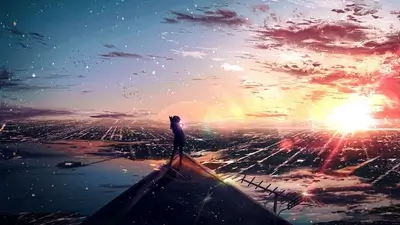 Girl standing on a rooftop overlooking a city at sunset