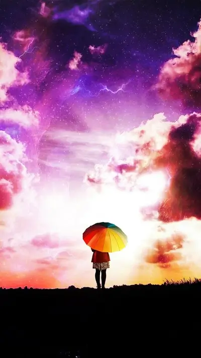 Girl with rainbow umbrella under a vibrant sky