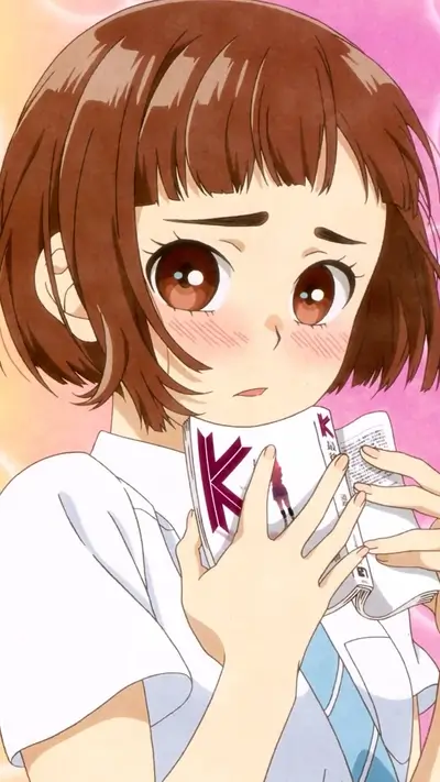 Girl with short brown hair holding open book with letter 'K'