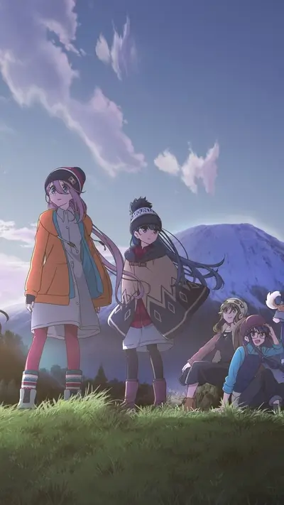 Girls standing on a hill overlooking a mountain