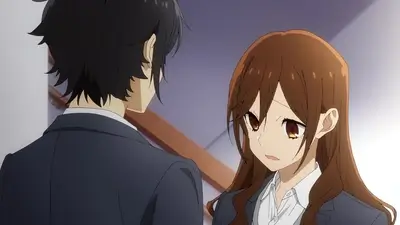 High school boy and girl talking closely in a school hallway