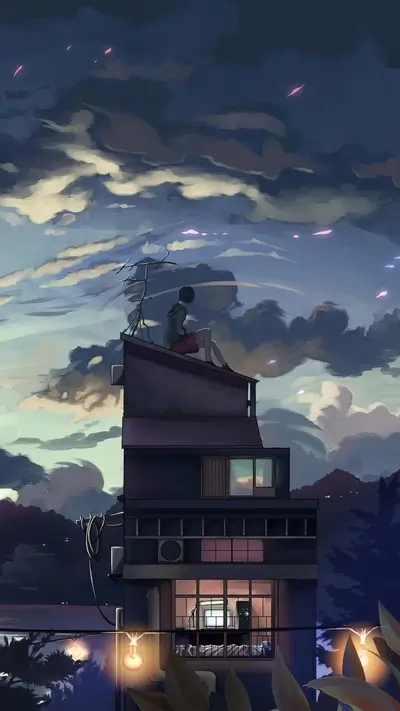 Lonesome figure sits atop building, enjoying the evening