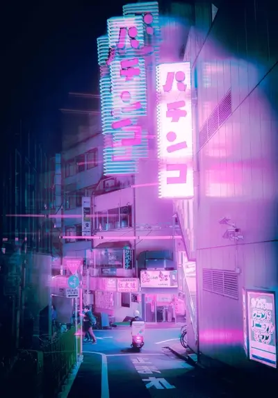 Neon signs illuminate a narrow street at night