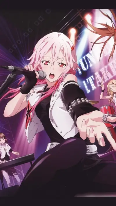 Pink-haired singer on stage with her band performing, lights and energy