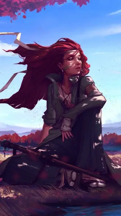 Red-haired woman sits by a lake, wind blowing hair