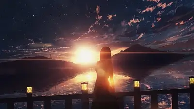 Silhouette of a girl watching the sunset over the water