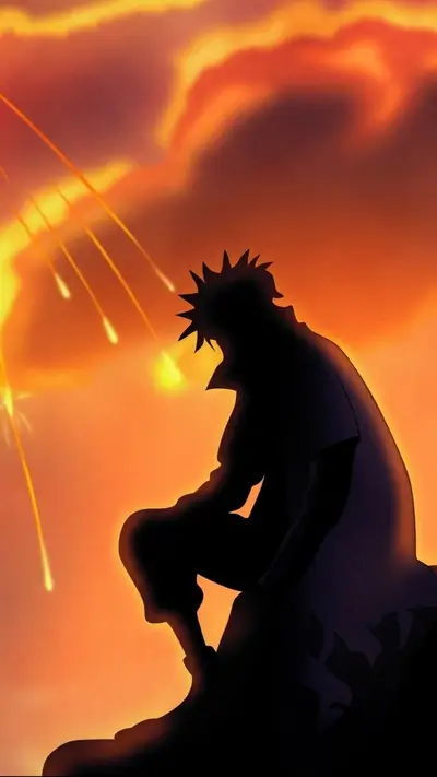 Silhouette of a person sitting on a rock at sunset