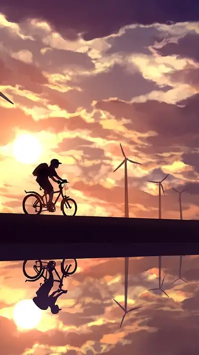 Silhouette of person riding bicycle with windmills in the background during sunset and water reflection