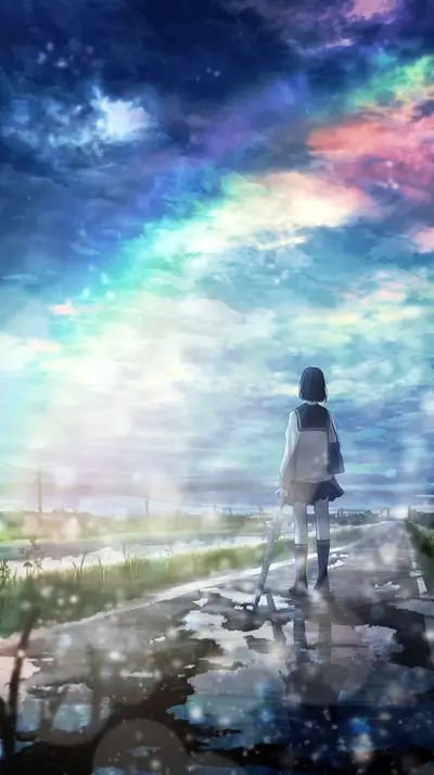 Standing on wet road, girl gazing up into colorful sky.