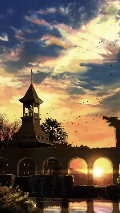 Sunset over a ruined structure with a bell tower