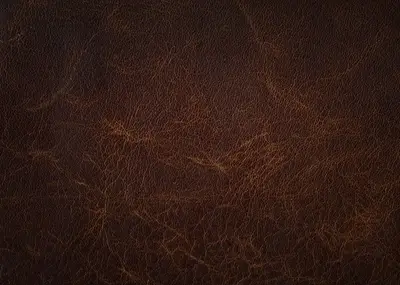 Textured close-up, presenting rich shades of brown and intricate, subtle lines