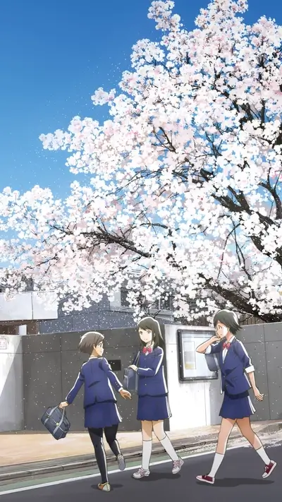 Three schoolgirls walking under cherry blossom tree on sidewalk