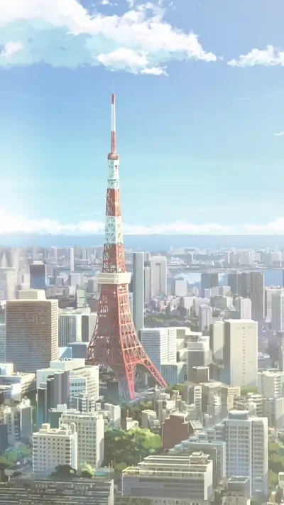Tokyo Tower rising high above modern city landscape, blue sky and clouds background